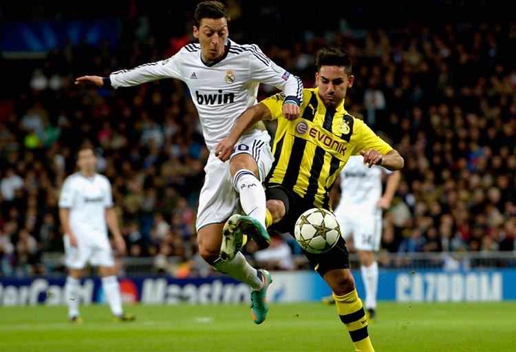 MADRID, SPAIN - NOVEMBER 06:  Mesut Oezil of Madrid and Ilkay Guendogan of Dortmund battle for the ball during the UEFA Champions League Group D match between Real Madrid and Borussia Dortmund at Estadio Santiago Bernabeu on November 6, 2012 in Madrid, Spain.  (Photo by Dennis Grombkowski/Bongarts/Getty Images)